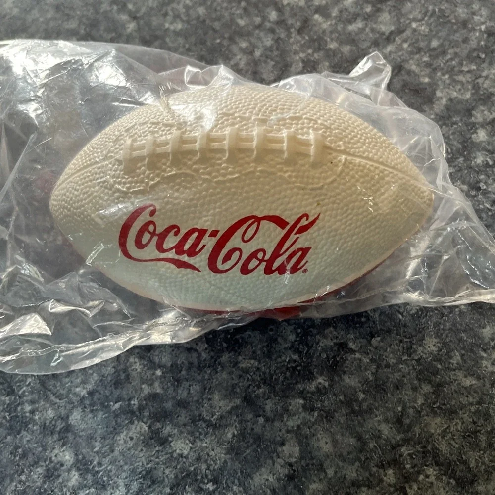 2 Collectible Coca Cola Mini Footballs. (1-leather, 1- foam) approx. 7 inches